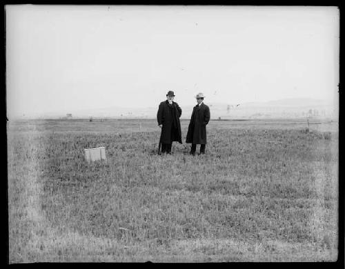 Two men posing in field