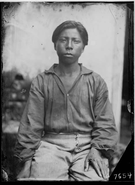 Half portrait of a man, frontal view, seated