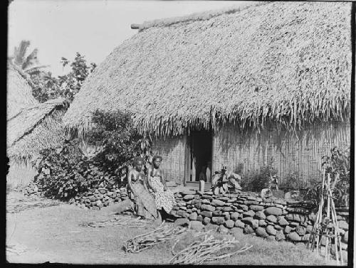 Two Women in front of Hut