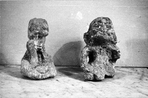 Two crude limestone figures