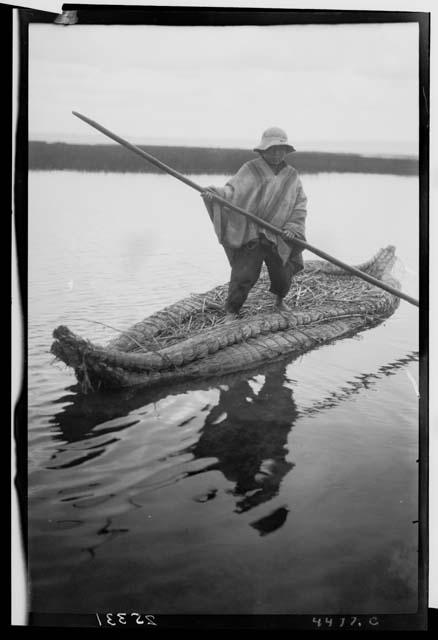 Man in reed boat on Lake Titicaca