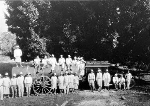 People standing around tank for water