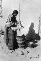 Woman using a butter churn