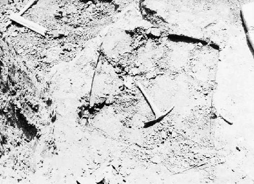 Excavation 1-31; Grave 1E. Excavation showing tools and impression of capstone