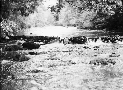 Fish traps in stream set in dam