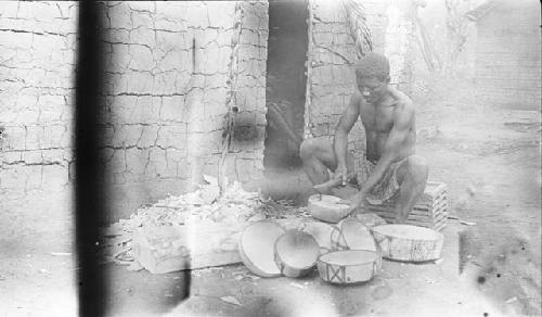Basa man making wooden bowls