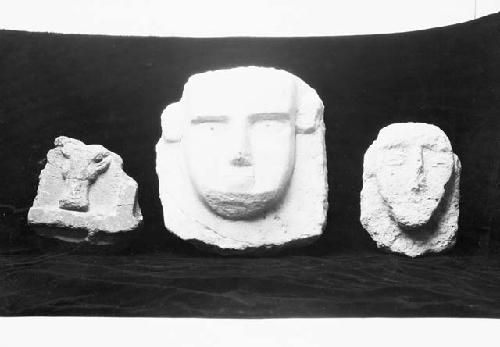 Three stone face reliefs