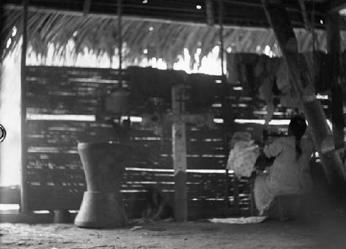 Woman working inside hut