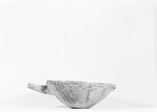 White painted pottery bowl with long spout and perforated lug
