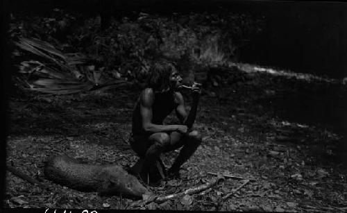 Man smoking pipe in jungle