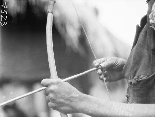 Close-up of arrow being drawn across bow