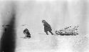 Man drawn sled with ice for drinking