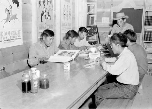 Hopi men in cook shack in evening