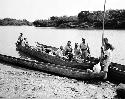 Men in boats along riverbank