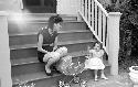 Small girl with woman on steps