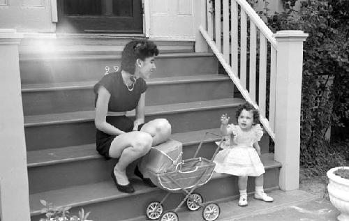 Small girl with woman on steps