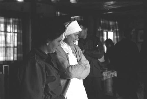 Nun and Military woman looking towards right.