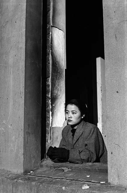 Woman looking out of window.