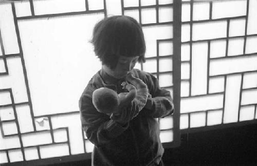 Girl holding baby doll