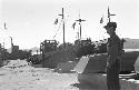 Man standing near ships at shipyard