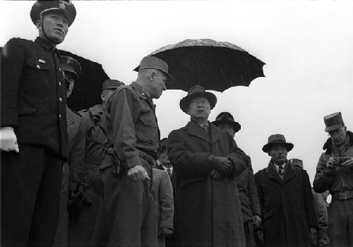 Military man talking with suited men. Military officers.