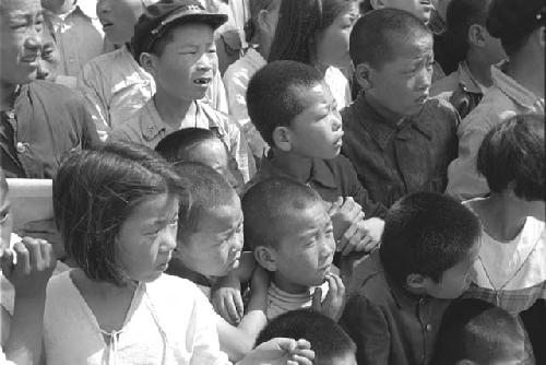 Crowd of children looking towards the right.