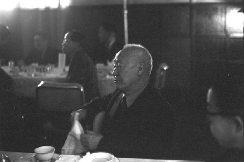 Man sitting at table in restaurant.