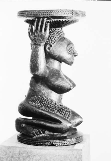 Side view of large Chief's stool with female sculpted form