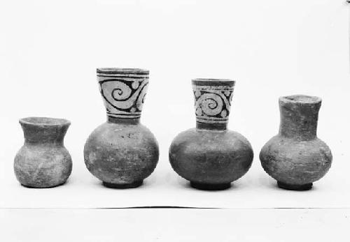 Four decorated pottery carafes