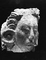 Carved stone head, possibly maize god or singing girl