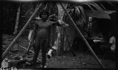 Man standing in front of wooden structure