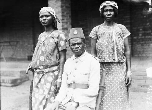 Male solider in uniform with two women in dresses and hats