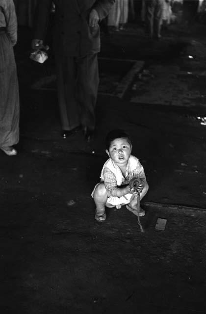 Boy crouching on ground