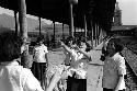 Schoolgirls playing on platform at train station