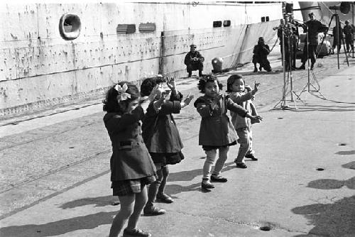 four girls performing on docks