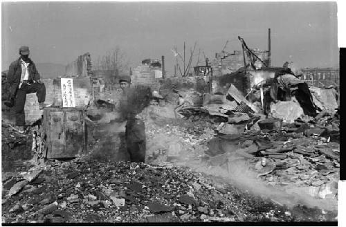 scene of rubble, two men working