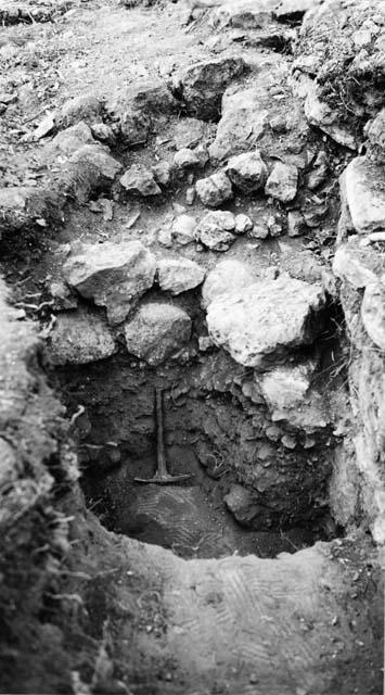 Trench along east wall of Q-99, showing retaining wall built out from wall