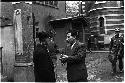 Two men speaking to each other outside a building