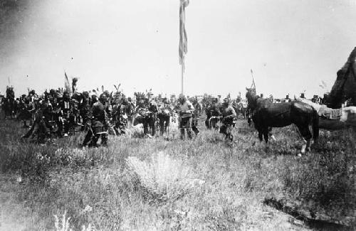 Indian men gathered around American flag, July 4, 1898