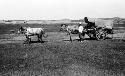 Man next to cart in front of settlement