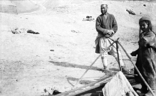 Loom with a man and girl standing alongside