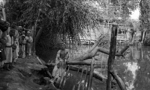 Boys standing near pool