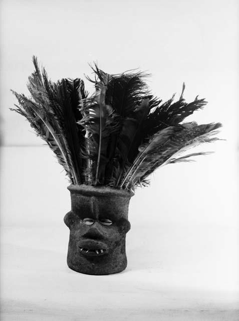 Small clay mask with feather headdress