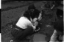 Two women washing a young child