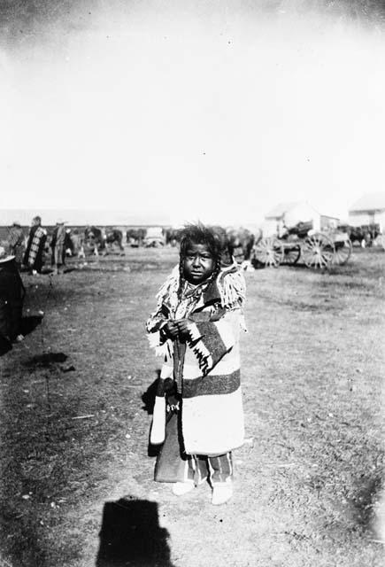 Crow Indian child, dressed in warm clothes