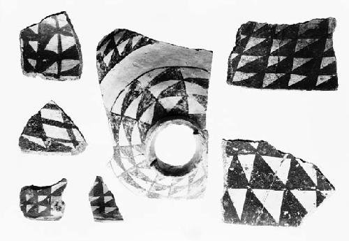 Black on white potsherds showing negative rhomboid and diamond designs