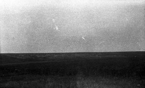 Distant view of village, half cultivated land