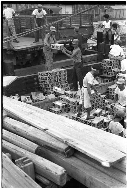 Men either loading or unloading a truck