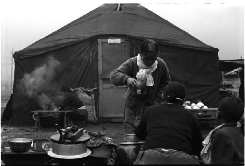 People eating outside of a tent