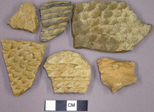 Corrugated potsherds, one possible limestone